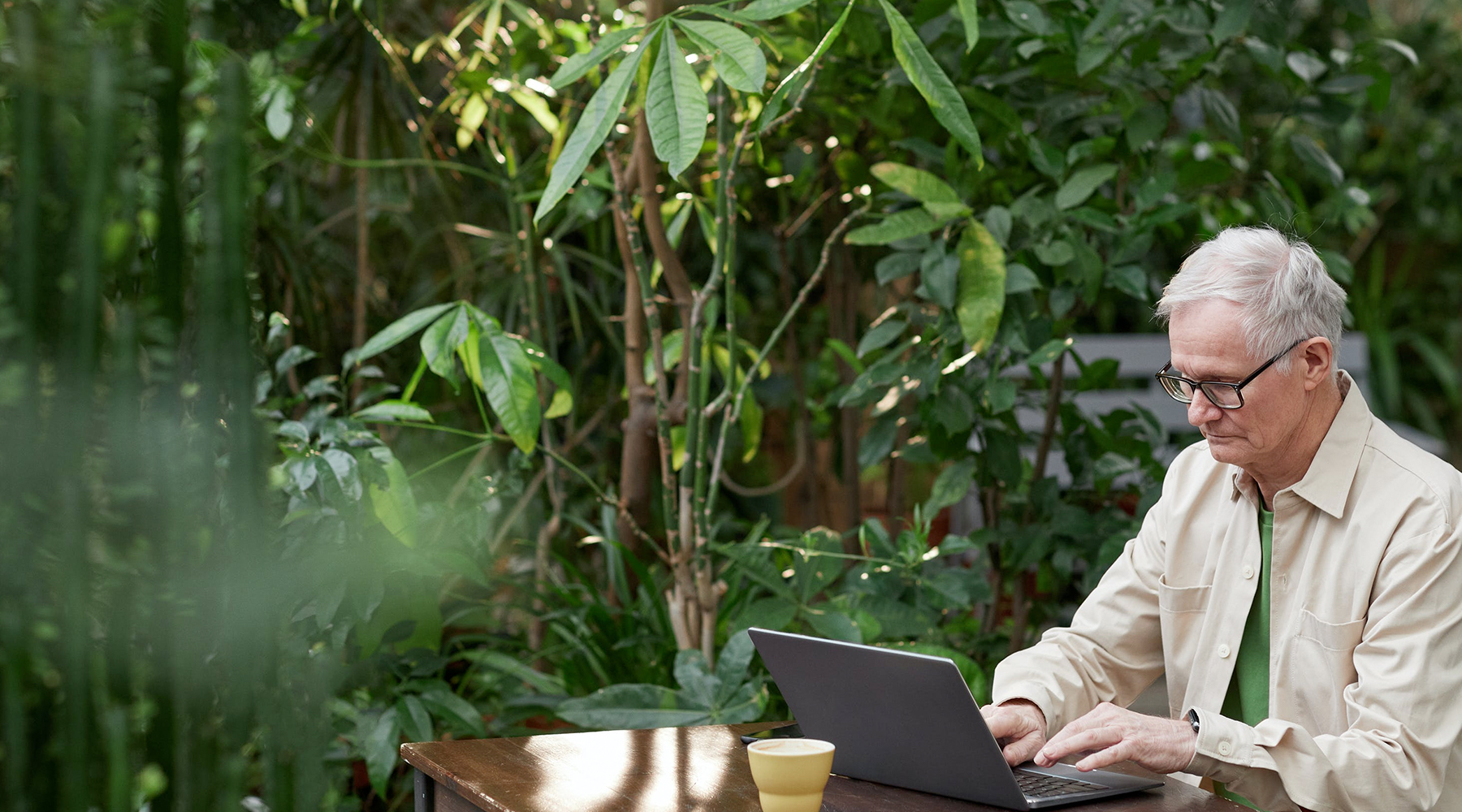 Person at laptop sitting outside