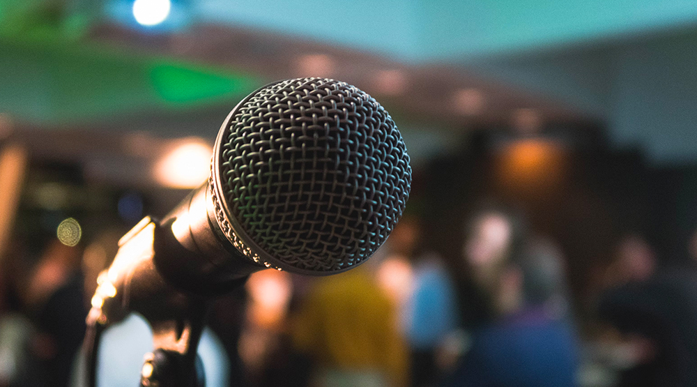 Extreme close up of microphone on stand with blurred background
