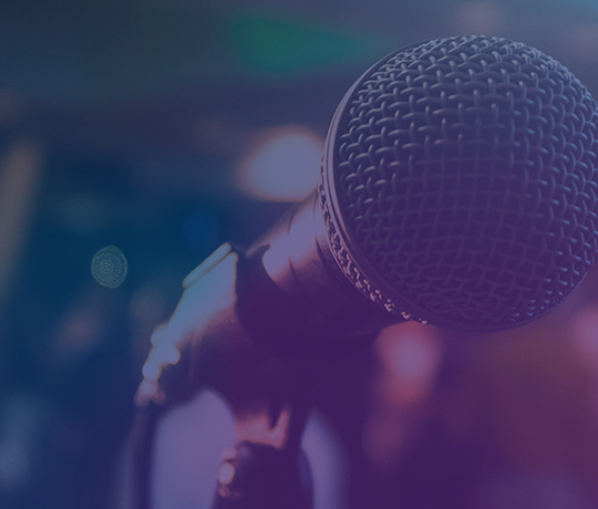 Extreme close up of microphone on stand with blurred background