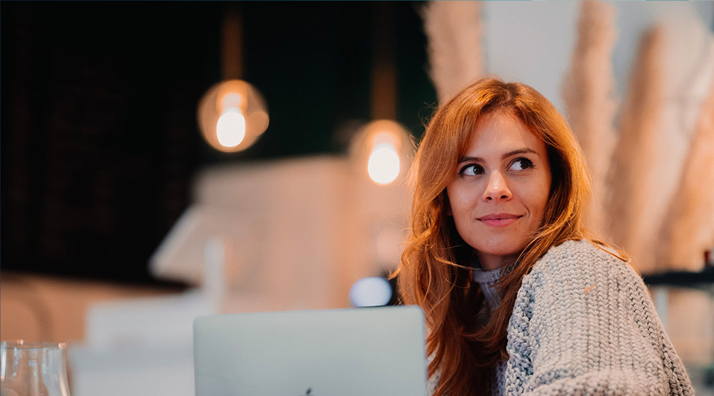 Person looking over shoulder slightly smiling 