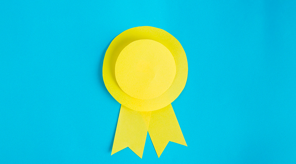 Paper cutout award on blue background