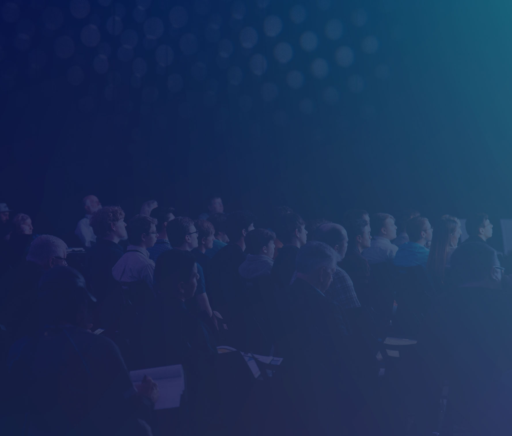 Crowd of people facing a stage at an association event