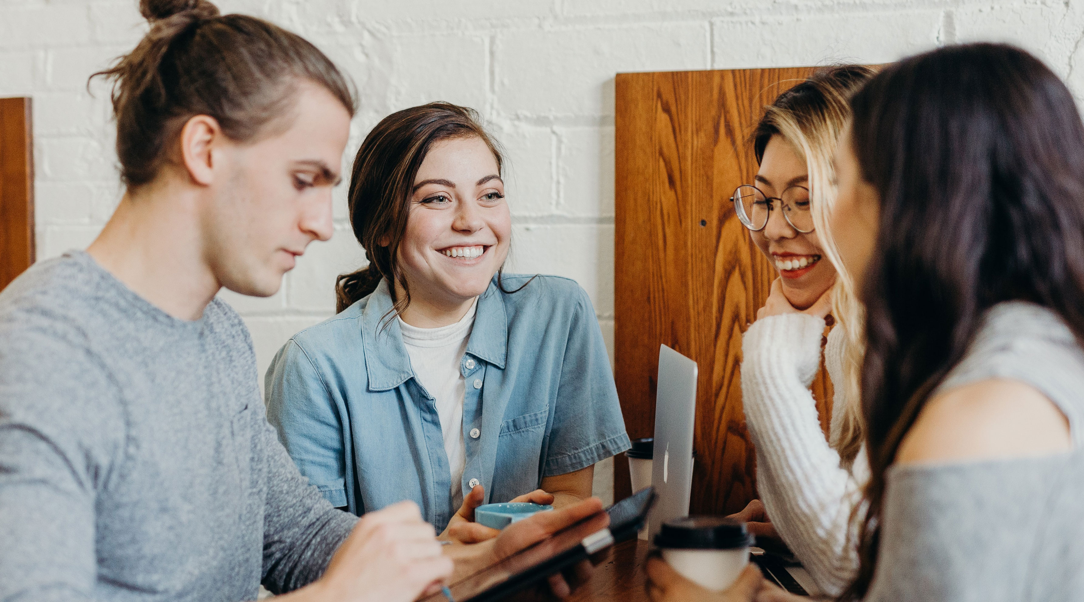 Group of people collaborating around a computer