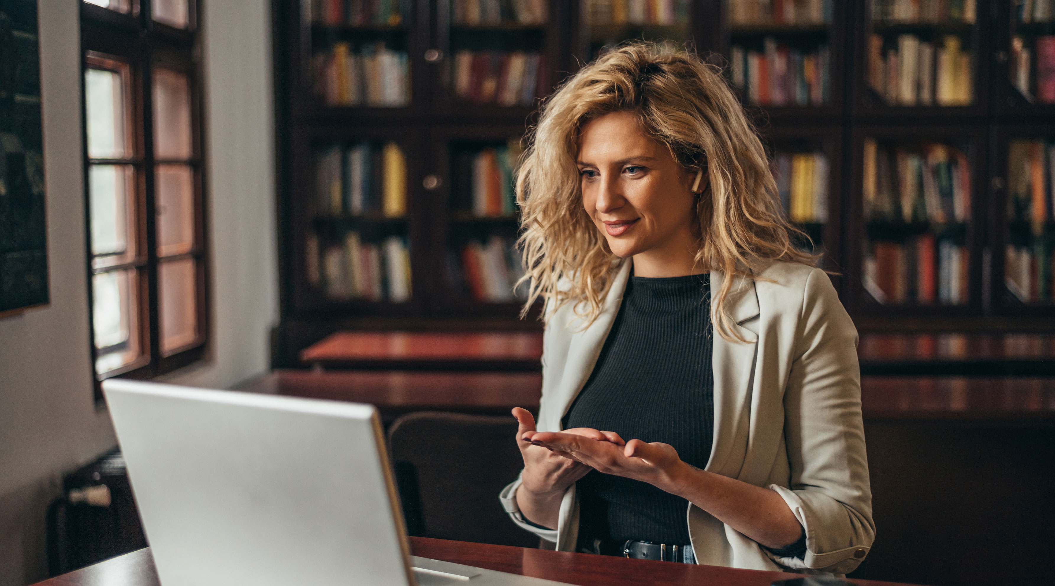 Woman presenting on a laptop during a virtual event
