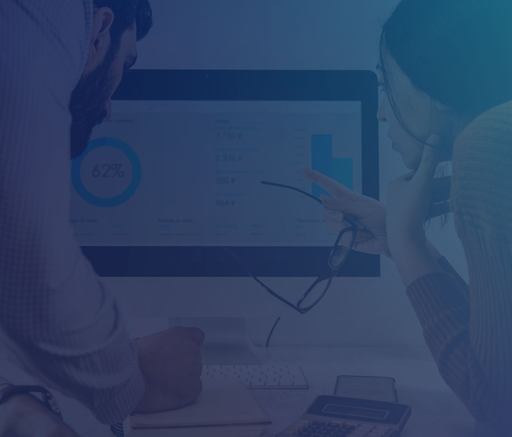 Man and woman looking at analytics data on computer screen