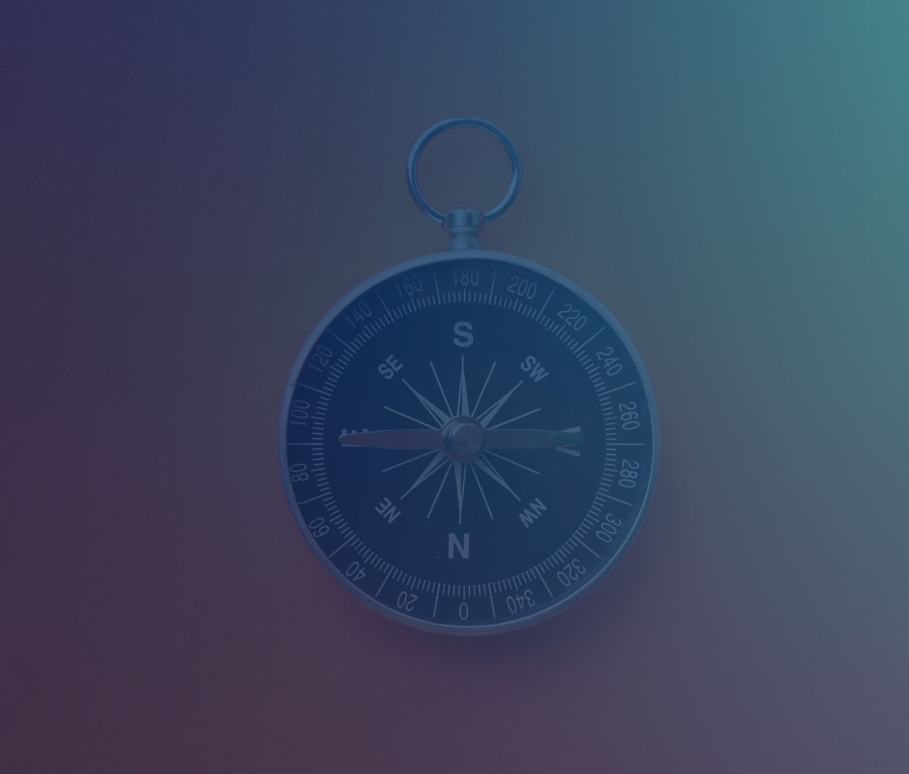 A silver compass with black face against a vibrant orange background. The compass is positioned on the right side of the image, leaving negative space on the left. The simple, minimalist composition suggests direction, guidance, and strategic decision-making.